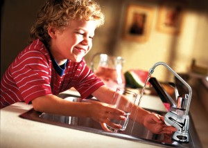 boy with glass and new faucet